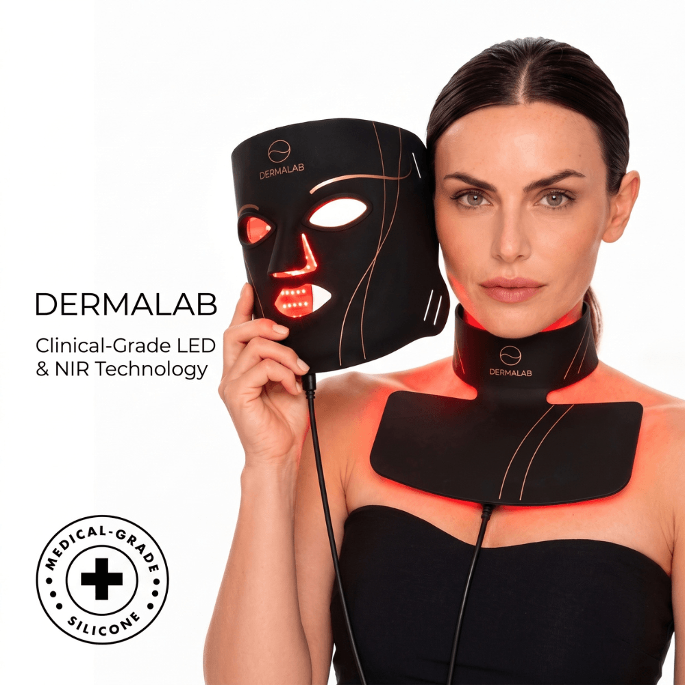 A woman wearing a Dermalab LED light therapy face mask and neck collar, holding an additional black face mask with glowing red light therapy elements. The image includes text overlays reading 'DERMALAB Clinical-Grade LED & NIR Technology' and a circular badge that says 'MEDICAL-GRADE SILICONE'.